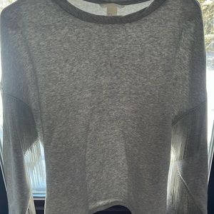 Woman’s gray sweatshirt with silver beaded strings hanging off each arm. size M